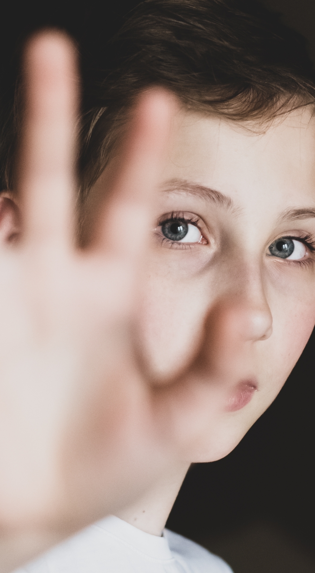 Child holding up one hand